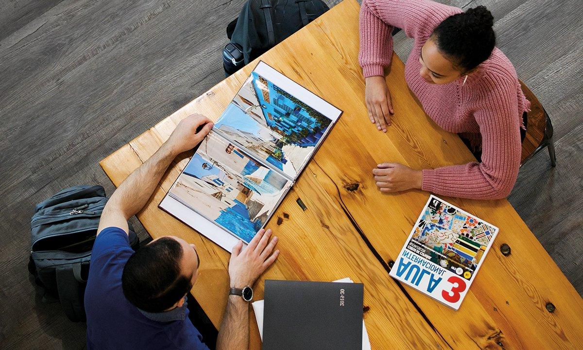 Overhead of two people at a table.